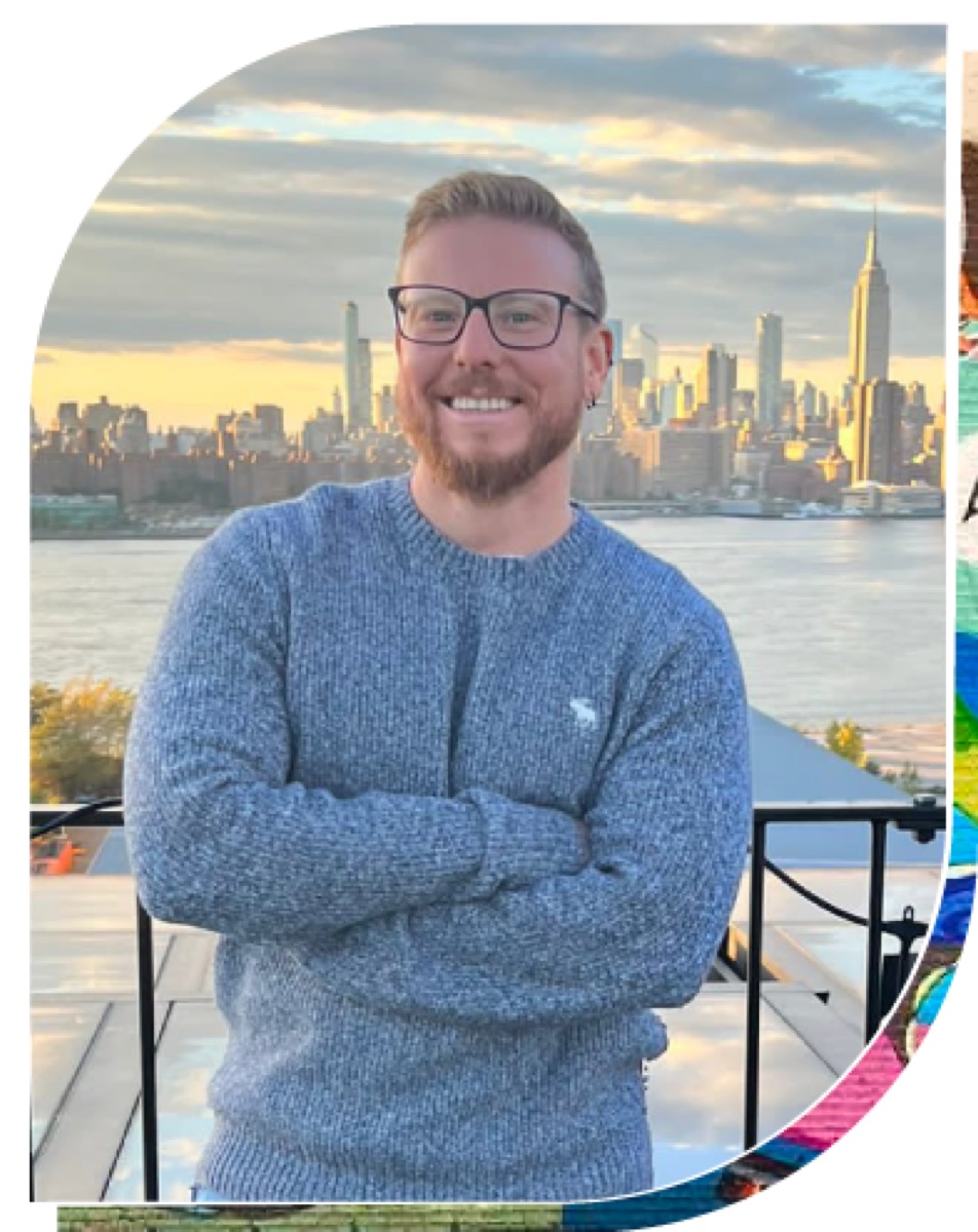 Andre Castro in a gray sweater with a city skyline behind him